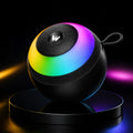 A spherical black portable speaker with a vibrant rainbow LED light ring, resting on a matching black circular base against a dark background.