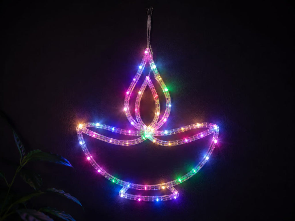 A hanging LED light shaped like a diya (oil lamp) glowing with multicolor lights against a dark background.