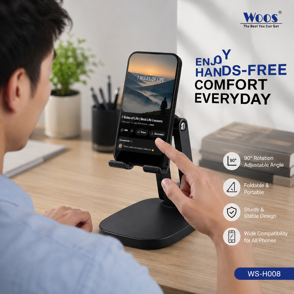 A person at a desk uses a black phone stand with a smartphone mounted upright. The scene includes marketing text and feature icons for the WOODS brand, showing a 90-degree adjustable angle, foldable and portable design, sturdy stable design, and wide compatibility for all phones.
